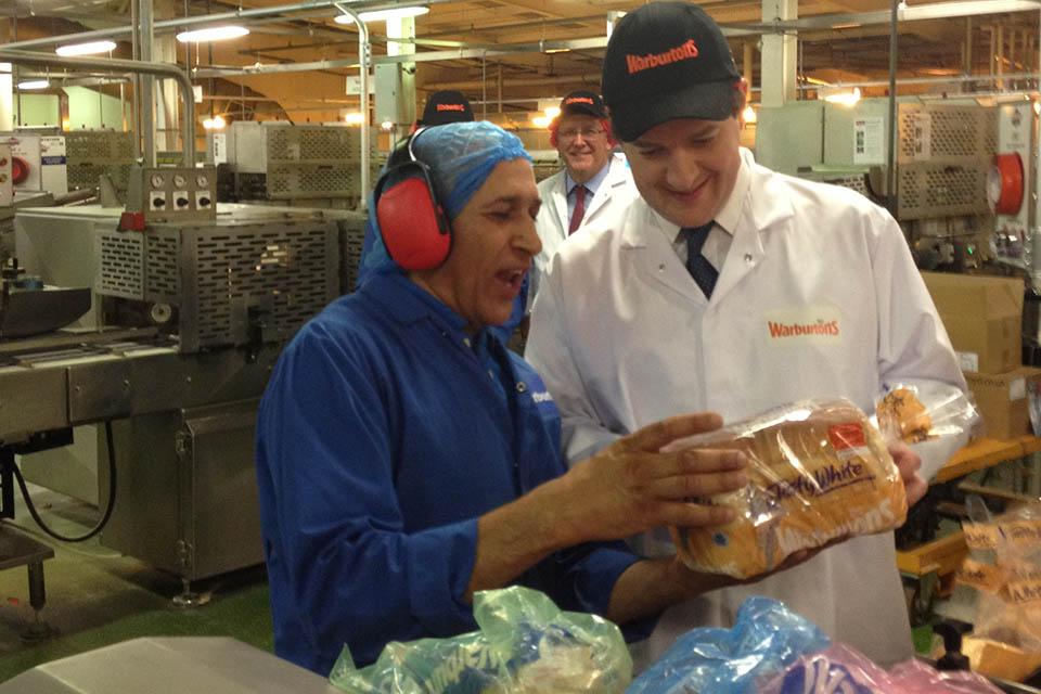 Chancellor and a shift worker at Warburtons inspecting a loaf of bread