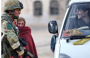 A soldier from 3 PARA talks to a young motorist in Naqilabad Kalay about career opportunities in the Afghan National Police