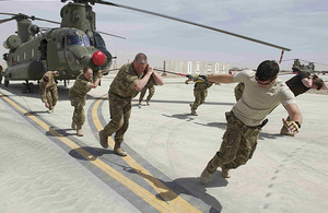 The airmen and airwomen of 1310 Flight pull a 16-tonne Chinook helicopter to raise money for Comic Relief at Camp Bastion in Helmand, southern Afghanistan