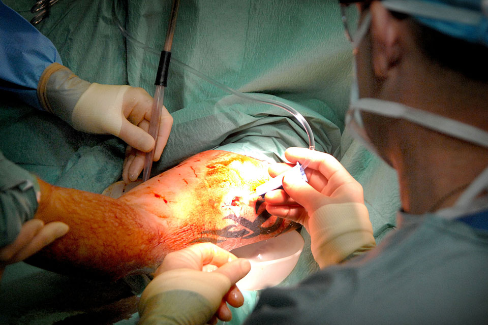 A soldier receives treatment for a gunshot wound