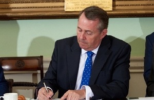 Secretary of State for International Trade, Liam Fox, signing the agreement