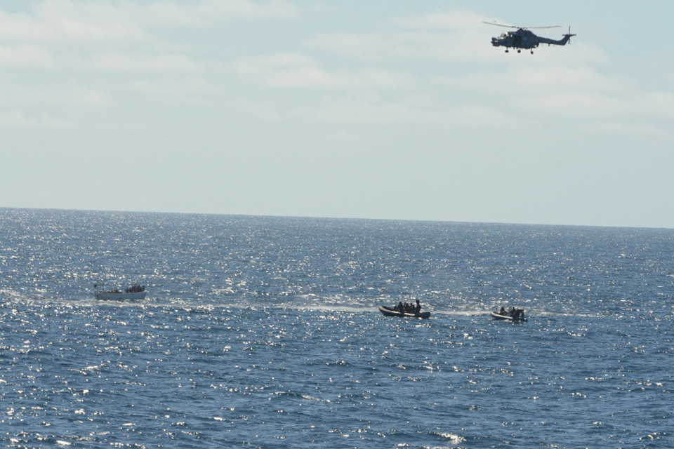 Boarding teams approach a suspected pirate vessel