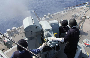 Sailors onboard HMS Bangor fire the ship's gun
