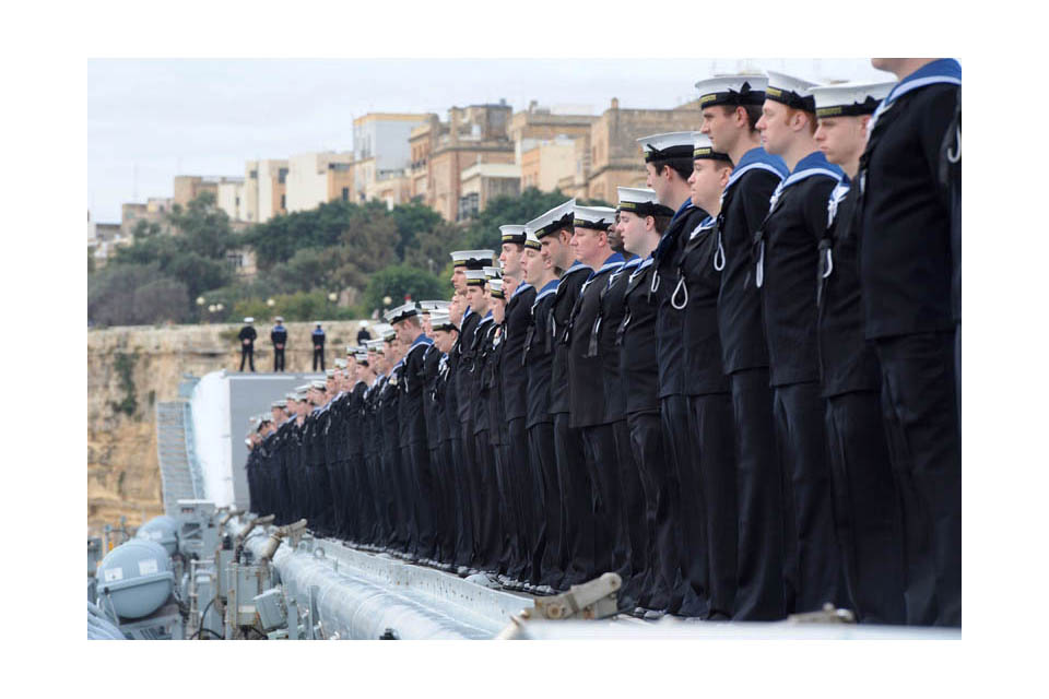 Sailors line the deck of HMS Illustrious
