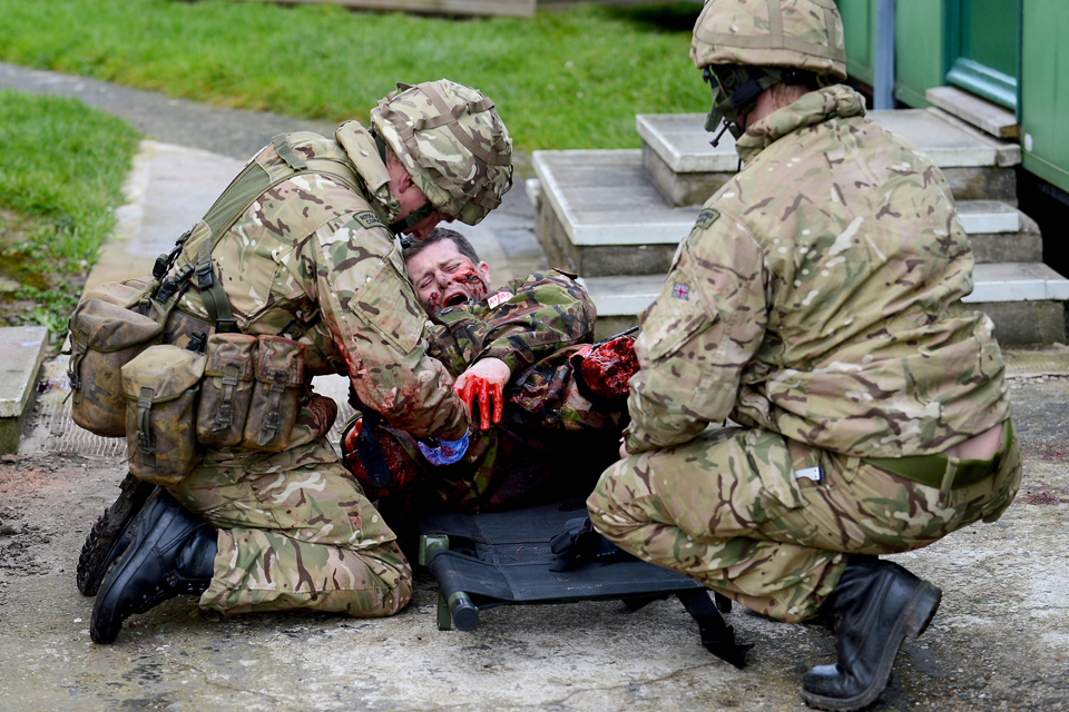 Commandos providing first aid to a battlefield 'casualty'