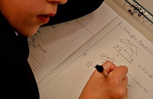 Pupil with maths book.