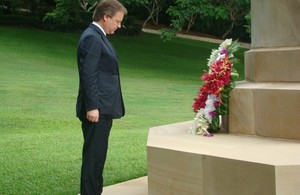 Minister Hugo Swire lays a wreath during his visit to the Bomana war cemetery