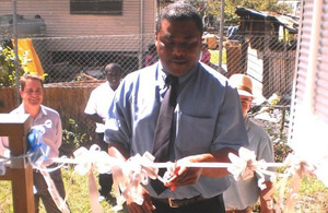 Hon. Chris Laore , cutting the ribbon to officially open Jubilee House