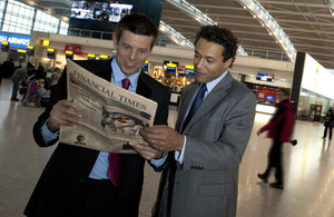 Businessmen read a copy of the Financial Times