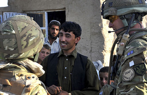 A British soldier talks to a local shop owner via an interpreter (left) (stock image)