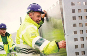 Environment Agency officers unloading flood barriers from truck in preparation for putting them up in an exercise to properties from flooding