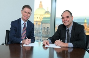 Gordon Welsh (UKEF) and Fred Smyth (Bank of Ireland) sign the agreement