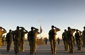 Garrison Sergeant Major Andrew Stephens (RAF) Lowers the Union flag for the last time at Kandahar Air base, Afghanistan [Picture: Corporal Andrew Morris (RAF), Crown copyright]