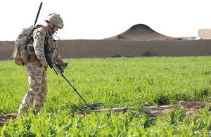 A British soldier carries out counter-IED drills during a patrol in Helmand province