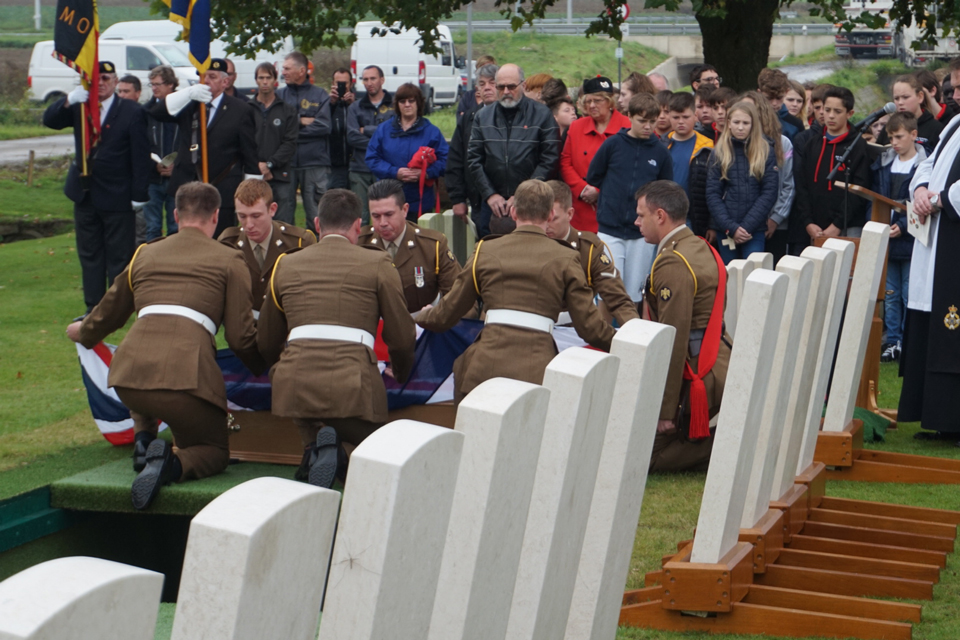 A bearer party prepare coffin to be lowered into the ground - Crown Copyright, All Rights Reserved