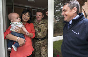 An accommodation officer with a service family outside a property.