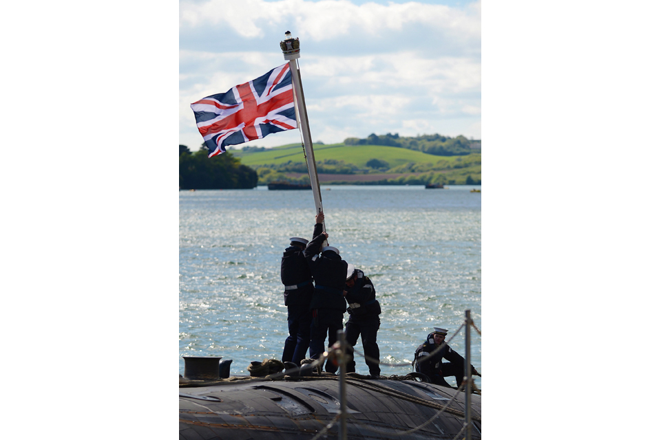 Submariners erect the Union Jack on HMS Trenchant's for'd casing