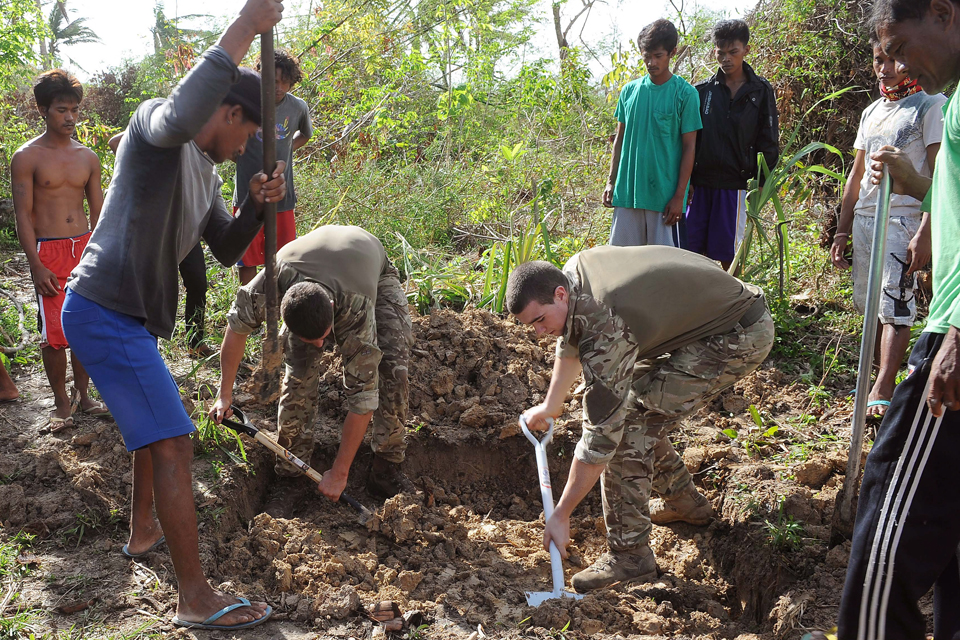 Royal Marines helping local villagers