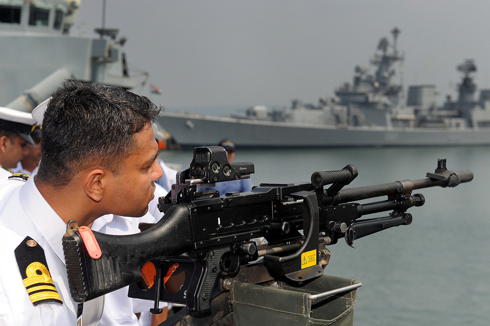 An Indian naval officer examines a British general purpose machine gun