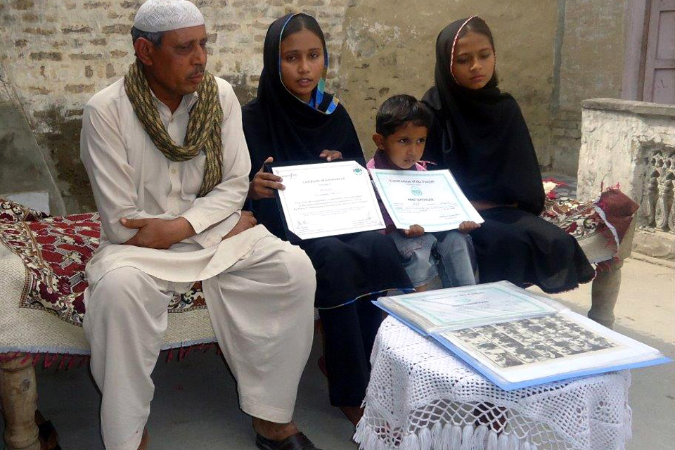 Faryal and her younger brother proudly show off her certificates of achievement. Picture: Punjab Education Foundation