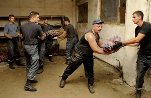 Men unload sacks of potatoes delivered by a humanitarian assistance convoy coordinated by the Red Cross in Ukraine. Picture: Teun Voeten/Panos