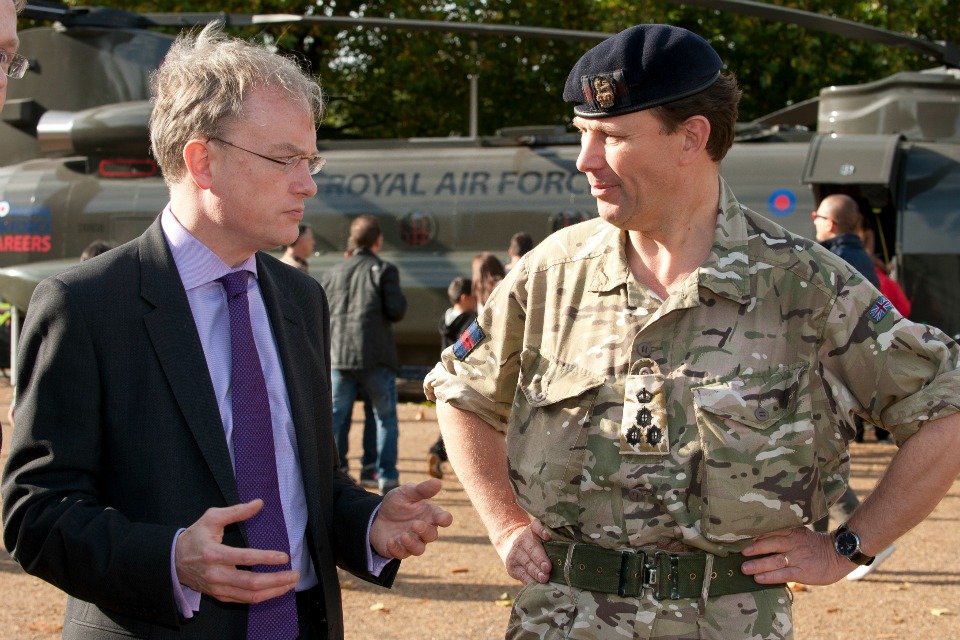 A civil servant talks to a member of the armed forces