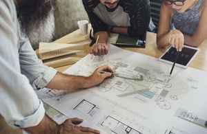 Colleagues collaborate on architecture design.