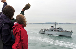 HMS Chiddingfold passes the Round Tower in Portsmouth, from where well-wishers welcome her home