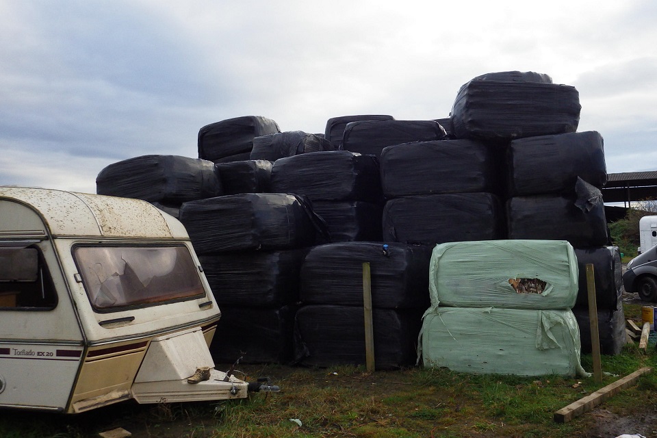 Image shows baled waste dumped on private land