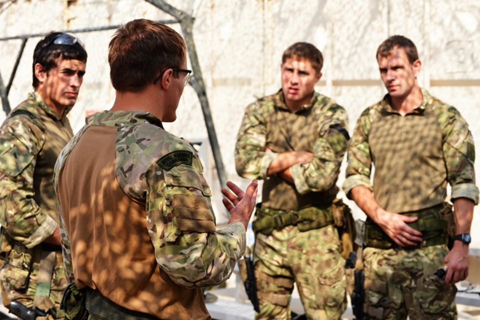 Captain Will Hall RM debriefs members of the team