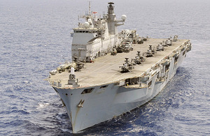 HMS Ocean with helicopters on deck including the USAF HH-60, Lynx Mk7, Sea Kings from 857 Naval Air Squadron, and Apaches from 656 Squadron Army Air Corps