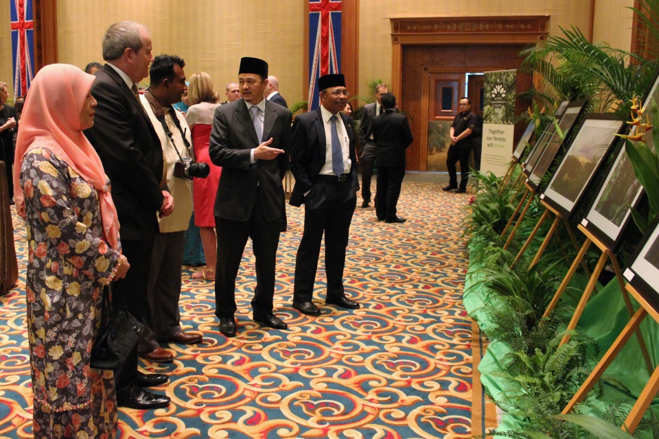 The Guests of Honour and British High Commissioner looking at pictures of Brunei's QCC dedications