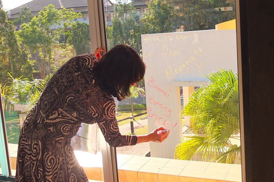 Margaret writes her quote on the E@C window: "The biggest challenge that we face is our own fear"