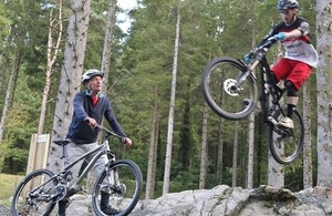 2014 Culture and Sports Minister, John Griffiths, watches local biker Owain James, who works at Trawsfynydd site, in the new skills area