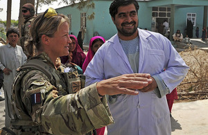 Sergeant Karen Swallow RAF with Dr Abdul Latif, the driving force behind the renovation of Gereshk District Hospital, in front of the new maternity wing