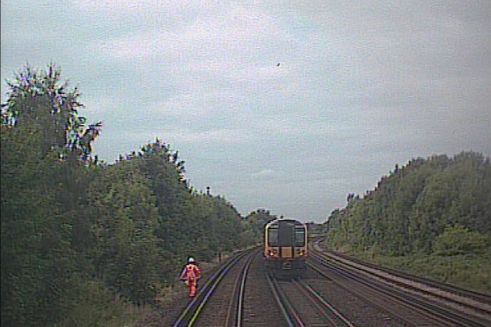 Forward facing CCTV image from the train that struck the track worker, looking towards Raynes Park, showing the rear of the first train having passing the distant lookout (courtesy of South Western Railway)