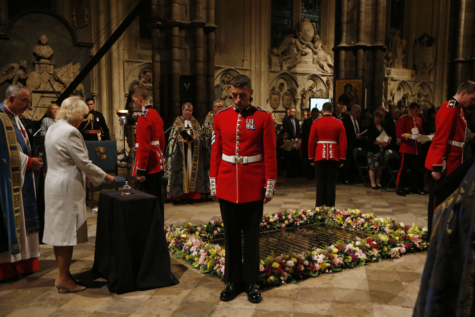 The Duchess of Cornwall extinguishes the remaining flame at the Grave of the Unknown Warrior at Westminster Abbey. 