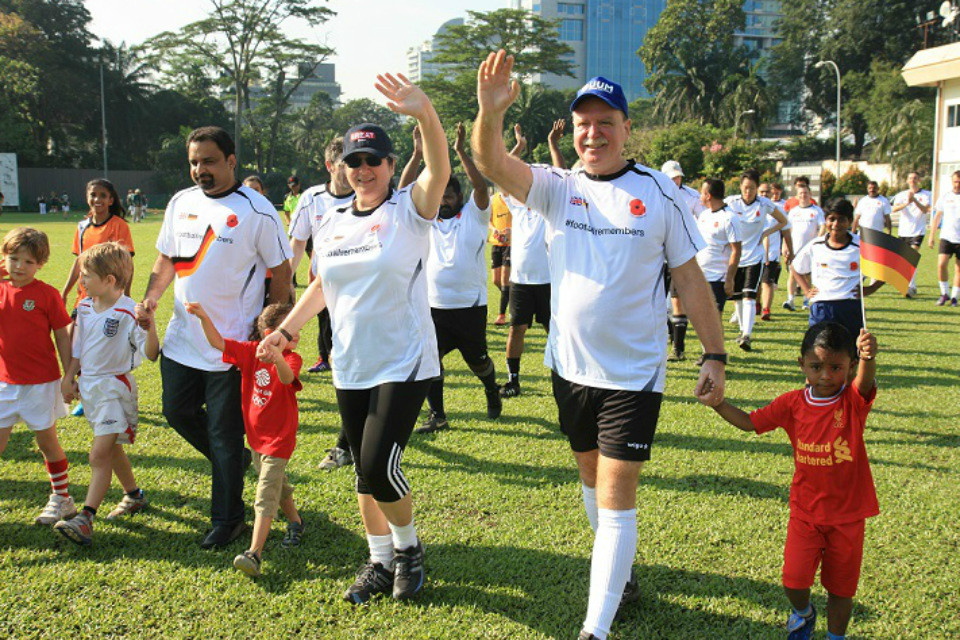 British High Commissioner to Malaysia Vicki Treadell CMG, MVO and German  Ambassador to Malaysia H.E. Holger Michael leading out the players at the #FootballRemembers match in Malaysia