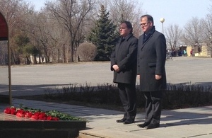 Keith Allan and Martin Harris laying flowers at the memorial