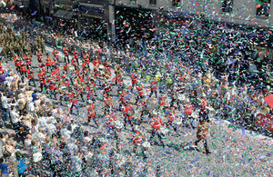 Confetti flies over the Armed Forces Day crowds