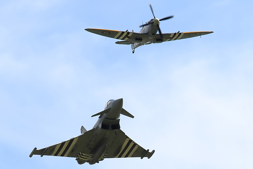 A Typhoon in flight with a Spitfire