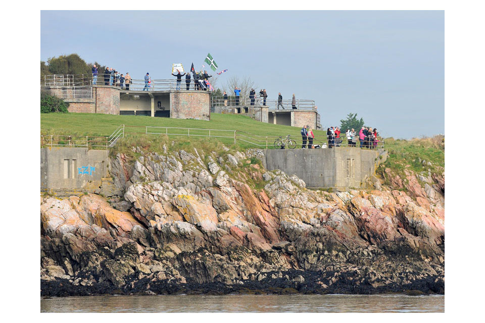 People wave from the shore