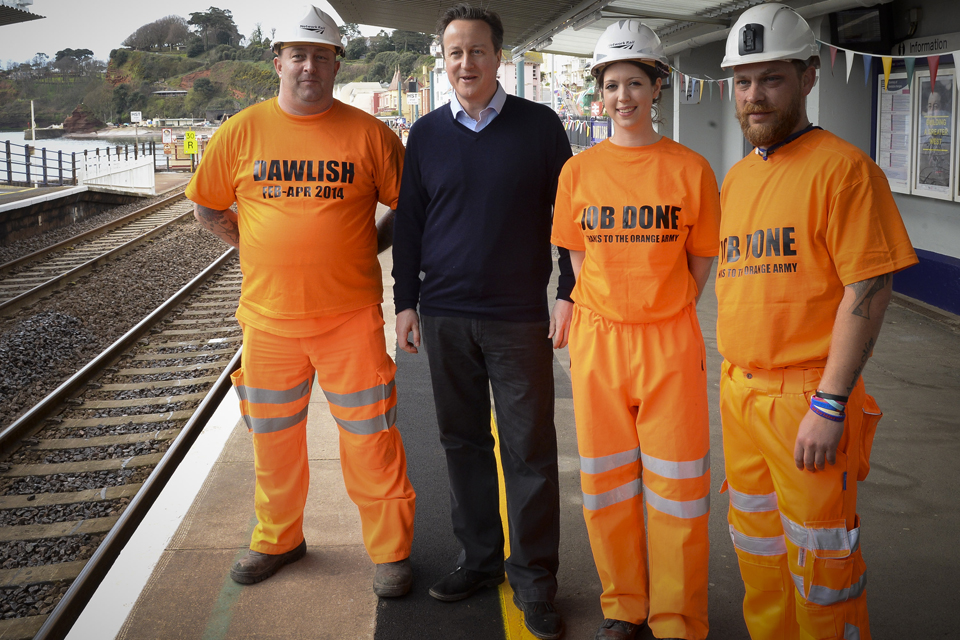 David Cameron poses with some of the 'Orange army' who helped repair the line.