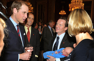 The Duke of Cambridge talks to Staff Sergeant Viv Vicary, of The Rifles, who holds his three-week-old son Hugo Eric Scott Vicary, and his wife Hanna during a reception to celebrate the Scott-Amundsen Centenary Race to the South Pole at Goldsmiths' Hall in