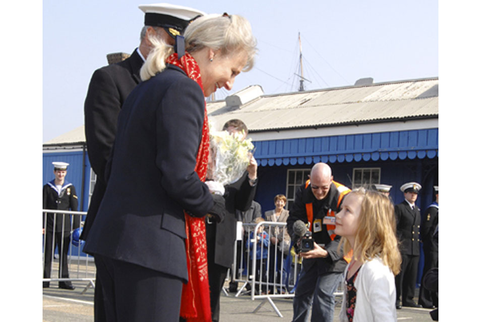 The Duchess of Gloucester receives flowers from Lieutenant Commander Stride's (the Executive Officer) daughter Catherine  