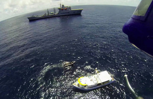 Suspect vessel Miss Tiffany is circled by Wave Knight's seaboat with the Royal Fleet Auxiliary supply ship seen in the background [Picture: Crown copyright]