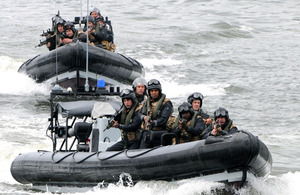 HMS Monmouth's boarding team approach the suspect vessel