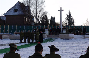 The coffin is lowered into the ground whilst prayers are read during the service for the first reburial at Fromelles on 30 January 2010