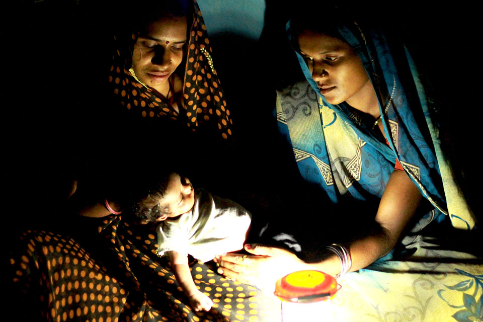 Picture of health worker with a mother and baby in India.