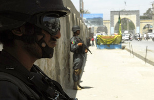 Afghan National Police on sentry duty at a marketplace in Kandahar City during a dismounted patrol